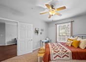 Thumbnail 32 of 56 - a bedroom with a bed and a ceiling fan