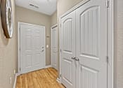 Thumbnail 35 of 56 - a Fenwyck Manor Apartment home hallway with two doors and a clock on the wall