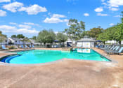 Thumbnail 15 of 18 - The large pool, new lounge chairs, and grilling stations at Rock Creek Apartments