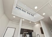 Thumbnail 5 of 25 - A high ceiling with lofted windows over a kitchen in an affor Brooke Street Loft