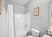 Thumbnail 35 of 56 - a bathroom with a bathtub and a toilet