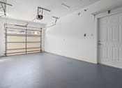 Thumbnail 13 of 28 - A white door is on the right side of a room with a grey floor.