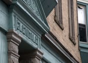 Thumbnail 2 of 12 - brick apartment building with a green and brown facade at 76 Grant St in Buffalo, NY
