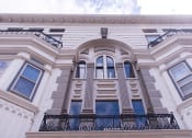 Thumbnail 6 of 12 - a white building with an arched window and balcony