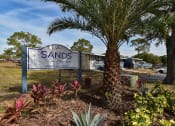 Thumbnail 1 of 36 - The monument sign for The Sands on Clearlake surrounded by lush landscaping and palm trees