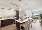 Thumbnail 16 of 40 - A modern kitchen with a dining table and chairs.