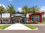 Thumbnail 4 of 30 - Clubhouse exterior with beautiful palm trees
