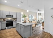 Thumbnail 24 of 43 - an open kitchen and living room area with a counter top and