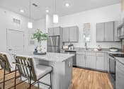 Thumbnail 25 of 43 - a kitchen with stainless steel appliances and a marble counter top