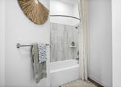 Thumbnail 34 of 43 - a bathroom with a shower curtain and a bath tub