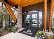 Thumbnail 2 of 43 - the front door of a canyon car dealership with a welcome mat on the sidewalk