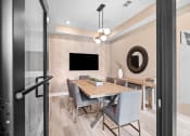 Thumbnail 7 of 43 - a dining room with a table and chairs