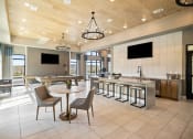 Thumbnail 3 of 43 - a large lobby with tables and chairs and a kitchen