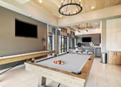 Thumbnail 5 of 43 - a pool table in a living room with a tv