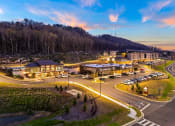 Thumbnail 42 of 43 - an aerial view of a hotel and parking lot at dusk