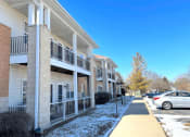 Thumbnail 3 of 24 - several private apartment balconies in front of the parking lot with snow on the ground at Algonquin Manor