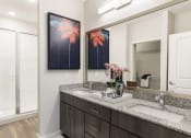 Thumbnail 27 of 44 - Designer bathroom with granite countertops and double sinks at Residences at The Green in Lakewood Ranch, FL