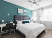 Thumbnail 26 of 44 - Bedroom with ceiling fan and large windows at Residences at The Green in Lakewood Ranch, FL