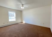 Thumbnail 17 of 24 - a bedroom with a ceiling fan, large window, and baseboard heater