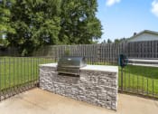 Thumbnail 28 of 28 - a stone outdoor grill in a backyard with a fence