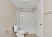 Thumbnail 13 of 14 - A bathroom with toilet, tub, and shower at Mountainside Apartments