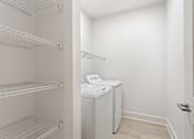 Thumbnail 8 of 37 - a laundry room with a washer and dryer and a closet with shelves