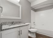 Thumbnail 27 of 28 - a bathroom with a toilet and a sink and a bath tub