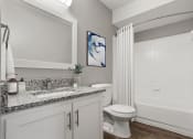 Thumbnail 18 of 28 - a bathroom with a shower and a toilet and a sink