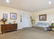 Thumbnail 6 of 16 - a lobby with a couch, credenza, and elevator at Village Square