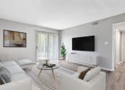 Thumbnail 6 of 28 - our apartments offer a living room with a couch and a tv