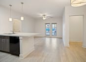 Thumbnail 5 of 37 - a kitchen and living room with a white counter top and a ceiling fan