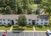 Thumbnail 5 of 28 - an aerial view of an apartment building in a parking lot