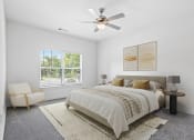 Thumbnail 2 of 57 - a bedroom with a bed and a ceiling fan