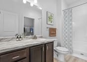 Thumbnail 7 of 57 - a bathroom with a sink and a toilet and a shower