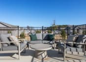 Thumbnail 15 of 48 - an inviting patio furniture set with sumptuous cushions on the pool deck at Sanctuary at Indian Creek