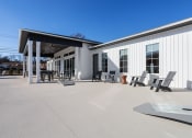 Thumbnail 16 of 48 - the patio and pool deck with sitting areas and cornhole boards at Sanctuary at Indian Creek Rental Homes in North Alabama