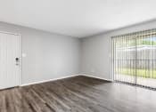 Thumbnail 23 of 28 - an empty living room with a door to a patio