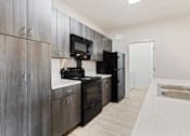 Thumbnail 1 of 37 - a kitchen with black appliances and a sink and a refrigerator