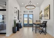 Thumbnail 1 of 48 - The welcoming entrance with glass doors and decor at Sanctuary at Indian Creek's Clubhouse