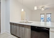Thumbnail 2 of 37 - an empty kitchen with a sink and a ceiling fan