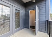 Thumbnail 11 of 37 - the front porch of a with doors and a door open to a doorway
