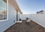 Thumbnail 31 of 48 - a single home fenced back yard with a small patio and furniture set at Sanctuary at Indian Creek
