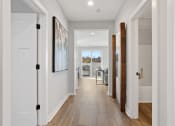 Thumbnail 32 of 48 - a long hallway with a doors leading to a kitchen and a dining room in a home at Sanctuary at Indian Creek