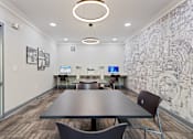 Thumbnail 15 of 37 - a conference room with a table and chairs and a wall with a mural