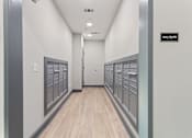 Thumbnail 14 of 37 - a view of the mailboxes in a long hallway with wood floors