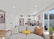 Thumbnail 44 of 48 - a living room with a couch and a kitchen in the background in a home at Sanctuary at Indian Creek