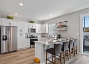 Thumbnail 45 of 48 - a kitchen with a large island and a stainless steel refrigerator at Sanctuary at Indian Creek rental homes near Redstone Arsenal