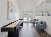 Thumbnail 8 of 28 - a living room with a piano and two chairs and a sliding glass door