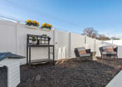 Thumbnail 48 of 48 - a fenced backyard with decor, a dog house, and flowers on the fence at Sanctuary at Indian Creek Rental Homes in Madison near Huntsville