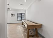 Thumbnail 25 of 37 - a pool table in a room with white walls and wood floors